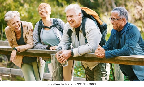 Elderly, people hiking and happy in park with fitness outdoor, relax on bridge while trekking in nature together. Health, wellness and hiker group, sport and active lifestyle motivation with cardio. - Powered by Shutterstock