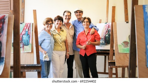 Elderly People Painting For Hobby. Group Of Active Seniors At Art School. Portrait Of Happy Group Of Old Friends With Senior Teacher Smiling, Looking At Camera.