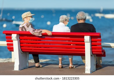 elderly people sitting on a bench wearing the mask - Powered by Shutterstock