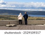 Elderly people stand on the observation deck and enjoy the views of nature