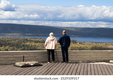 Elderly people stand on the observation deck and enjoy the views of nature - Powered by Shutterstock