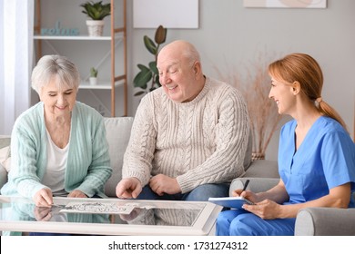 Elderly people suffering from mental disability and caregiver in nursing home - Shutterstock ID 1731274312