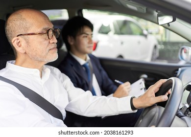 Elderly People Taking Training In Driving A Car