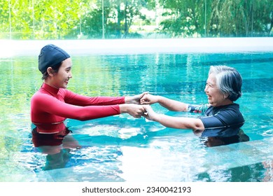 Elderly person doing physiotherapy in water. Female staff doing physiotherapy for seniors. exercise for the elderly - Powered by Shutterstock