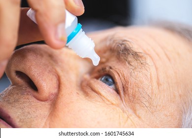 Elderly Person Puts Eye Drops In The Eye. Senior Man Putting Eye Drop 