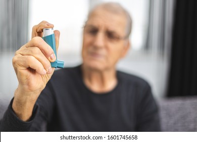 Elderly Person Using An Asthma Spray. Senior Man Ready For Using An Asthma Inhaler