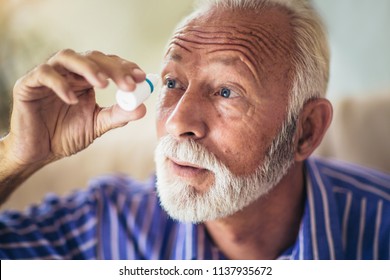 Elderly Person Using Eye Drops