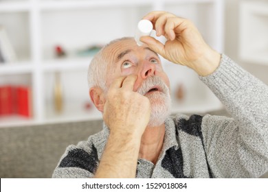 Elderly Person Using Eye Drops