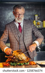 Elderly Respectable Housefather Dressed In Formal Expensive Mens Suit, Treats His Big Family With Fried Chicken At A Family Dinner