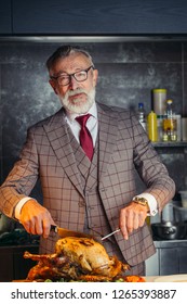 Elderly Respectable Housefather Dressed In Formal Expensive Mens Suit, Treats His Big Family With Fried Chicken At A Family Dinner