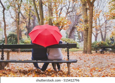 elderly retired couple sitting together on the bench in autumn park, love concept - Powered by Shutterstock