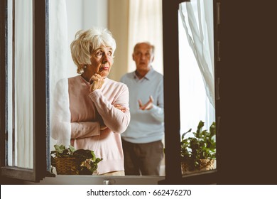 Elderly Sad Woman Giving Her Husband Silent Treatment In Apartment