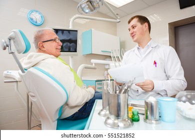 Elderly Senior Man On A Review Of A Dentist, Sitting In A Chair