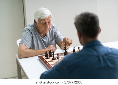 Elderly Senior Playing Chess Table Board Game