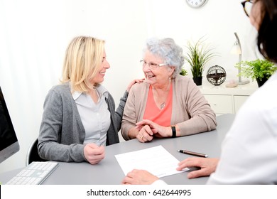 Elderly Senior Woman With Daughter Signature Legacy Heritage Testament Document In A Lawyer Notary Office 