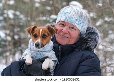 Elderly Senior Woman Holding Small Jack Russell Terrier Dog On Hands, They're Wearing Matching Knitted Jumper And Headband