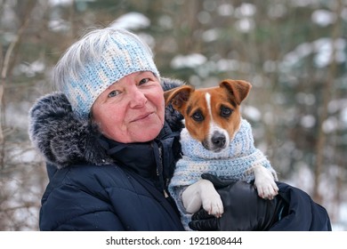 Elderly Senior Woman Holding Small Jack Russell Terrier Dog On Hands, They're Wearing Matching Knitted Jumper And Headband