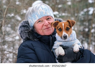 Elderly Senior Woman Holding Small Jack Russell Terrier Dog On Hands, They're Wearing Matching Knitted Jumper And Headband