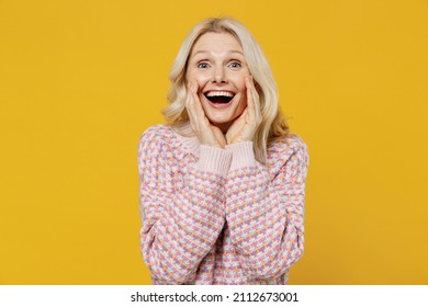 Elderly Smiling Blonde Caucasian Woman 50s In Pink Sweater Scream Hot News About Sales Discount With Hands Near Mouth Isolated On Plain Yellow Color Background Studio Portrait People Lifestyle Concept