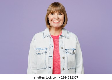Elderly smiling happy fun cheerful blonde satisfied woman 50s years old she wearing casual clothes denim jacket t-shirt looking camera isolated on plain pastel light purple background studio portrait - Shutterstock ID 2244812327