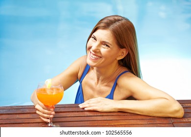 Elderly smiling woman with cocktail in a swimming pool - Powered by Shutterstock