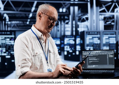 Elderly technician coding in high tech data center using javascript language. Certified specialist updating software on server rigs on laptop terminal, ensuring optimal performance and security - Powered by Shutterstock - Get 15% off with code: PIKWIZARD15