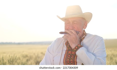 An Elderly Ukrainian In An Embroidered Jacket Plays The Harmonica.