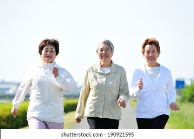 Elderly Woman Of Asian Of Three People Walking Down The Road