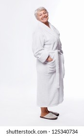 Elderly Woman In A Bathrobe On A White Background