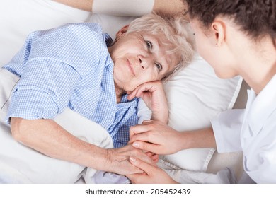 Elderly Woman In Bed And Her Nurse