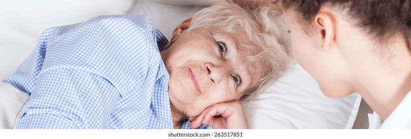 Elderly Woman In Bed And Her Nurse