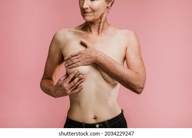 Elderly woman being aware of breast cancer - Powered by Shutterstock