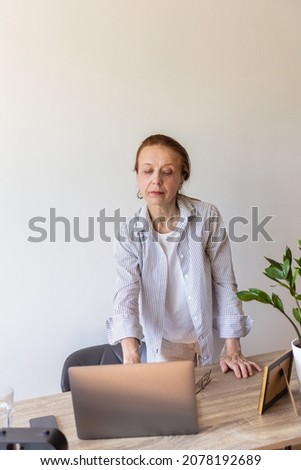 Similar – Young female sitting by table and making clay or ceramic mug in her working studio