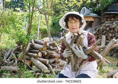 Elderly Woman Chopping Firewood