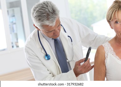 Elderly Woman Consulting Doctor For Skin Control