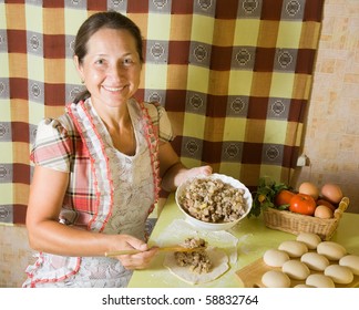 Elderly Woman Cooking Meat Pasty At Kitchen