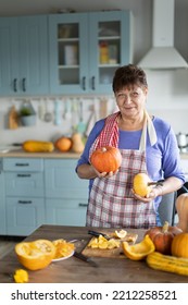 Elderly Woman Cooking Pumpkin In The Kitchen