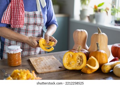 Elderly Woman Cooking Pumpkin In The Kitchen