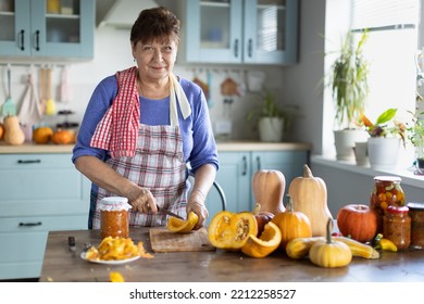 Elderly Woman Cooking Pumpkin In The Kitchen