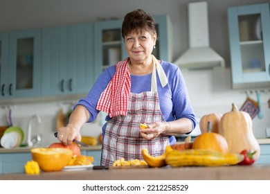 Elderly Woman Cooking Pumpkin In The Kitchen