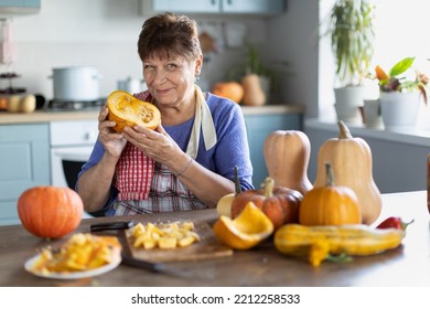 Elderly Woman Cooking Pumpkin In The Kitchen