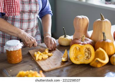 Elderly Woman Cooking Pumpkin In The Kitchen