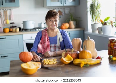 Elderly Woman Cooking Pumpkin In The Kitchen