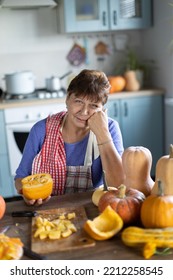 Elderly Woman Cooking Pumpkin In The Kitchen