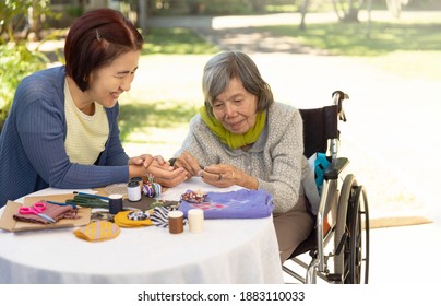 Elderly Woman And Daughter In The Needle Crafts Occupational Therapy For Alzheimer’s Or Dementia