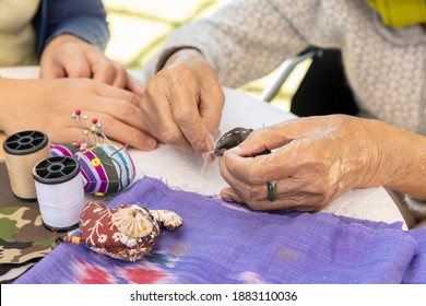 Elderly Woman And Daughter In The Needle Crafts Occupational Therapy For Alzheimer’s Or Dementia