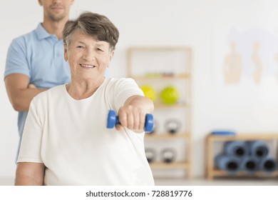 Elderly Woman Doing Active, Isometric Exercises Guided By Physical Therapist At The Hospital Rehabilitation Center