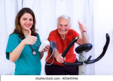 Elderly Woman Doing Sport Effort On A Spinning Bike Having Hear Hart Rate And Blood Pressure Monitored.