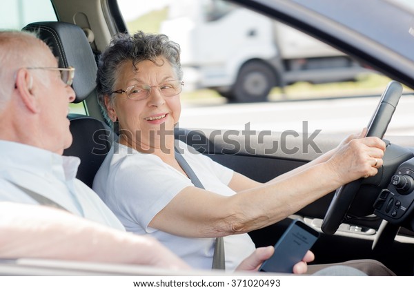 elderly woman\
driving