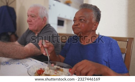 Elderly woman eating lunch at meal time, a group of diverse senior over meal. Close-up of a Brazilian older lady eats food